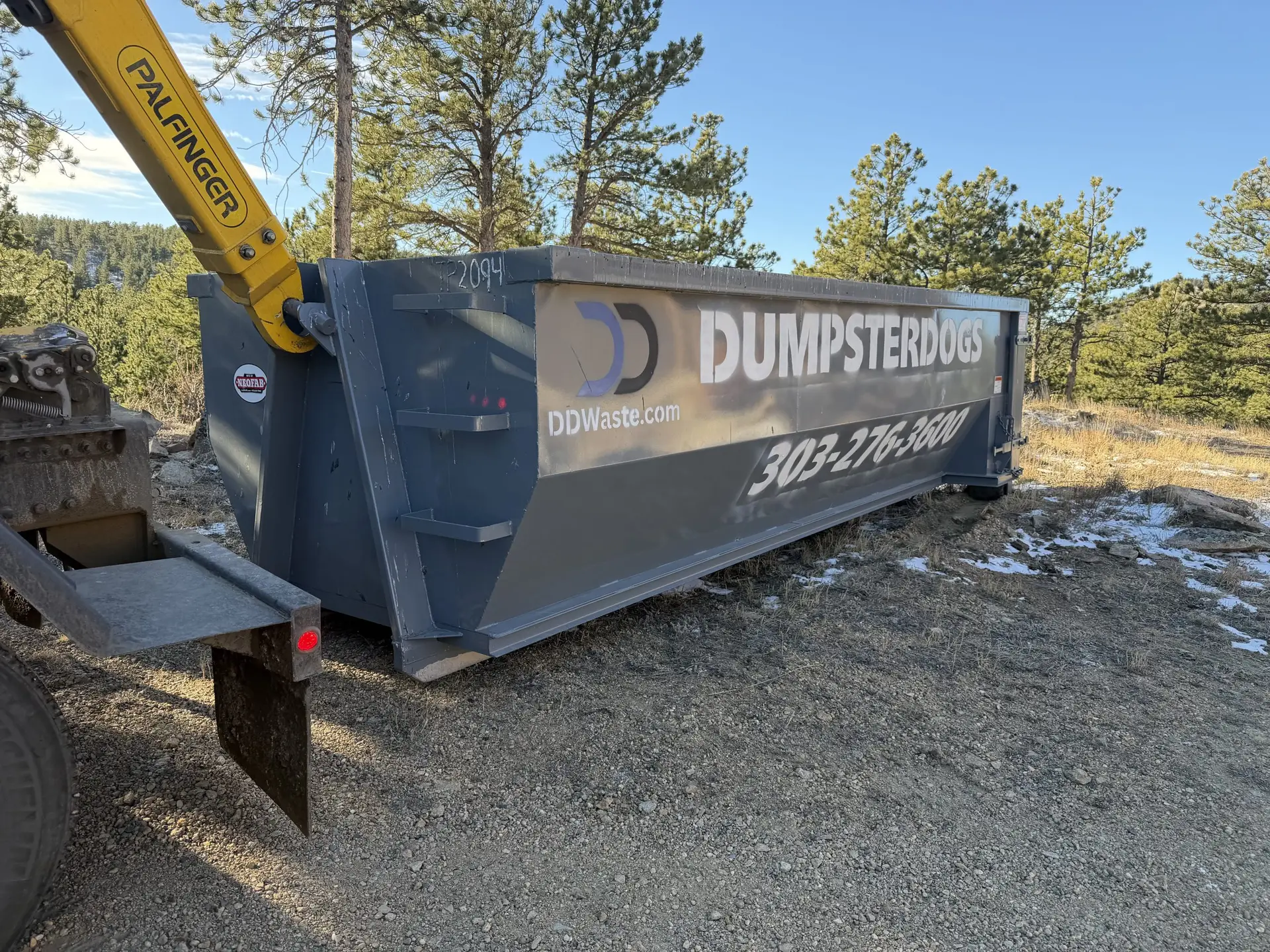 20 yard construction dumpster in Boulder Colorado driveway