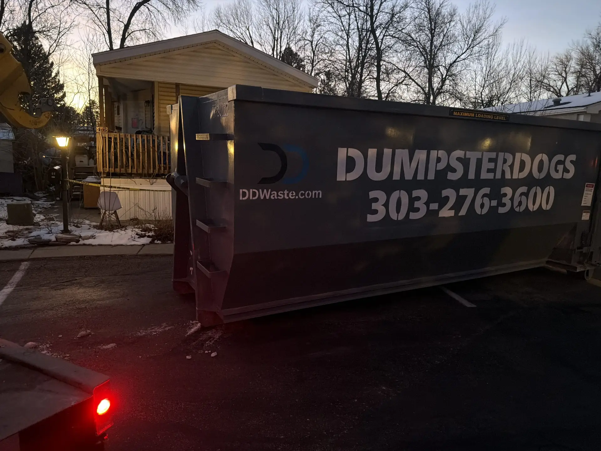 20 yard construction dumpster in Boulder Colorado driveway